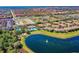 Aerial view showcases a tranquil lake, pool, and tennis court, adding to the community's appeal at 7526 Pellham Way, Kissimmee, FL 34747