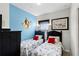 Bright bedroom featuring twin beds with colorful accents and a playful Disney theme at 7526 Pellham Way, Kissimmee, FL 34747
