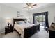 Comfortable bedroom with a king-sized bed and access to a private balcony with seating at 7526 Pellham Way, Kissimmee, FL 34747