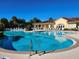 Beautiful community pool and clubhouse with ample seating, surrounded by lush greenery at 7526 Pellham Way, Kissimmee, FL 34747