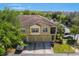 Charming townhome boasts a tile roof, 3-car garage, and lush landscaping, offering curb appeal and ample parking at 7526 Pellham Way, Kissimmee, FL 34747