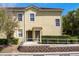 Charming townhome with well-maintained landscaping, a tiled roof, and a cozy, welcoming facade at 7526 Pellham Way, Kissimmee, FL 34747