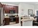 This kitchen features dark wood cabinets, stainless steel appliances, and a breakfast bar at 7526 Pellham Way, Kissimmee, FL 34747