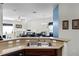 Open-concept kitchen with a stainless steel sink overlooking a spacious living area at 7526 Pellham Way, Kissimmee, FL 34747