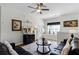 Comfortable living room area featuring a ceiling fan, a large window, and a cozy seating arrangement at 7526 Pellham Way, Kissimmee, FL 34747