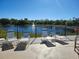 Relax by the community lake on comfortable lounge chairs and enjoy the peaceful scenery at 7526 Pellham Way, Kissimmee, FL 34747