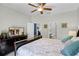 Spacious main bedroom with a ceiling fan, and ensuite bathroom at 7526 Pellham Way, Kissimmee, FL 34747