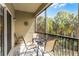 Relax on this screened patio with a table set, offering beautiful views of lush tropical foliage and sunny skies at 7526 Pellham Way, Kissimmee, FL 34747