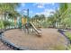 Outdoor playground with slides, ladders, and geometric climbing structure surrounded by lush tropical landscaping at 7526 Pellham Way, Kissimmee, FL 34747