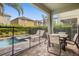 Covered back porch with outdoor furniture and view of fenced pool at 7615 Brookhurst Ln, Kissimmee, FL 34747