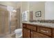 Bathroom features a glass-enclosed shower and granite-topped vanity, offering a luxurious experience at 7615 Brookhurst Ln, Kissimmee, FL 34747