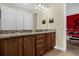 Bathroom with double sinks, granite countertops, and wood cabinets at 7615 Brookhurst Ln, Kissimmee, FL 34747