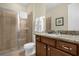 Bathroom features a glass-enclosed shower and granite-topped vanity, offering a luxurious experience at 7615 Brookhurst Ln, Kissimmee, FL 34747