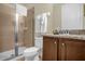 Bathroom features a glass-enclosed shower, toilet, granite vanity, and light wood cabinets at 7615 Brookhurst Ln, Kissimmee, FL 34747