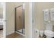 Bathroom showcases a glass-enclosed shower, toilet, and vanity with neutral walls at 7615 Brookhurst Ln, Kissimmee, FL 34747