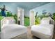 This bedroom features vibrant cartoon character wall art and two twin beds at 7615 Brookhurst Ln, Kissimmee, FL 34747