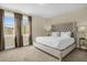 Comfortable bedroom with neutral tones, a plush bed, and natural light at 7615 Brookhurst Ln, Kissimmee, FL 34747