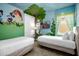 bedroom features two twin beds, a wall mural with Disney characters, and a TV for entertainment at 7615 Brookhurst Ln, Kissimmee, FL 34747