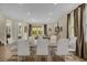 Elegant dining area with modern table, tile flooring, and access to the living room at 7615 Brookhurst Ln, Kissimmee, FL 34747