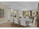 Elegant dining area with a modern table, tile flooring, and access to the living room at 7615 Brookhurst Ln, Kissimmee, FL 34747