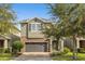 Charming two-story home with stone accents, a brick paver driveway and a two-car garage at 7615 Brookhurst Ln, Kissimmee, FL 34747