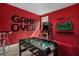 Spacious game room features a foosball table, arcade machine, and a fun game-themed mural at 7615 Brookhurst Ln, Kissimmee, FL 34747