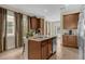 Modern kitchen with granite countertops, stainless steel appliances, and island seating at 7615 Brookhurst Ln, Kissimmee, FL 34747
