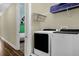 Laundry room with front load washer and dryer and view of themed bedroom at 7615 Brookhurst Ln, Kissimmee, FL 34747
