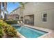 Backyard view of pool and spa with covered patio and outdoor furniture at 7615 Brookhurst Ln, Kissimmee, FL 34747