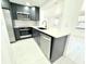 Well-lit kitchen featuring black cabinets, stainless steel appliances, quartz countertops, and a modern faucet enhancing the space at 817 Clay Blvd, Eustis, FL 32726