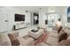 Stylishly furnished living room with light-colored sofa set, patterned rug, and views of the open kitchen and dining areas at 817 Clay Blvd, Eustis, FL 32726
