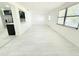 Open living space features plank flooring, neutral paint and transitions to a kitchen showcasing stainless steel appliances at 817 Clay Blvd, Eustis, FL 32726