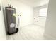 Utility room features a new water heater, clean walls, and plenty of space at 817 Clay Blvd, Eustis, FL 32726