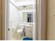 This bathroom offers a toilet, vanity, and a large mirror for a functional and well-lit space at 845 Orchid Springs Dr, Winter Haven, FL 33884