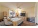 Comfortable bedroom featuring a ceiling fan, side cabinets, and a bright window for pleasant living at 845 Orchid Springs Dr, Winter Haven, FL 33884