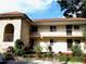 Two story condo building featuring stucco and stone exterior with well maintained landscaping at 845 Orchid Springs Dr, Winter Haven, FL 33884
