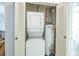 A laundry room with stacked washer and dryer, plus water heater at 845 Orchid Springs Dr, Winter Haven, FL 33884