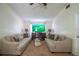Relaxing living room features cozy sofas and a large screen TV for ultimate home entertainment at 845 Orchid Springs Dr, Winter Haven, FL 33884