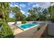 Tranquil community pool surrounded by lush trees and inviting lounge chairs at 845 Orchid Springs Dr, Winter Haven, FL 33884