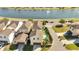 Beautiful home with a private pool, a well-maintained lawn, and a scenic view of the nearby lake at 8498 Powder Ridge Trl, Windermere, FL 34786