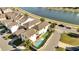 Aerial view of home featuring a private pool and play area near a picturesque lake at 8498 Powder Ridge Trl, Windermere, FL 34786