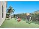 Spacious backyard with a play area, lush green turf, and a basketball hoop at 8498 Powder Ridge Trl, Windermere, FL 34786