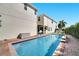 Backyard featuring a pool, turf, basketball hoop, and outdoor storage box at 8498 Powder Ridge Trl, Windermere, FL 34786
