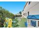 Expansive backyard with a pool, play area, lush green turf, and privacy hedges at 8498 Powder Ridge Trl, Windermere, FL 34786