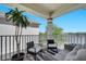 Inviting balcony featuring comfortable seating and a serene lake view at 8498 Powder Ridge Trl, Windermere, FL 34786