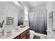Well-lit bathroom with a dark wood vanity and a shower featuring a stylish curtain at 8498 Powder Ridge Trl, Windermere, FL 34786