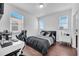 Bright bedroom featuring a desk, gaming chair, and modern decor at 8498 Powder Ridge Trl, Windermere, FL 34786