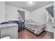 Bedroom features wood floors, curtains, and a small bed near a window at 8498 Powder Ridge Trl, Windermere, FL 34786