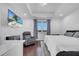 Modern bedroom featuring a large TV, neutral colors, and a comfortable sitting area at 8498 Powder Ridge Trl, Windermere, FL 34786