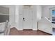 Bright foyer with a white front door, dark wood floors, and natural light from nearby windows at 8498 Powder Ridge Trl, Windermere, FL 34786